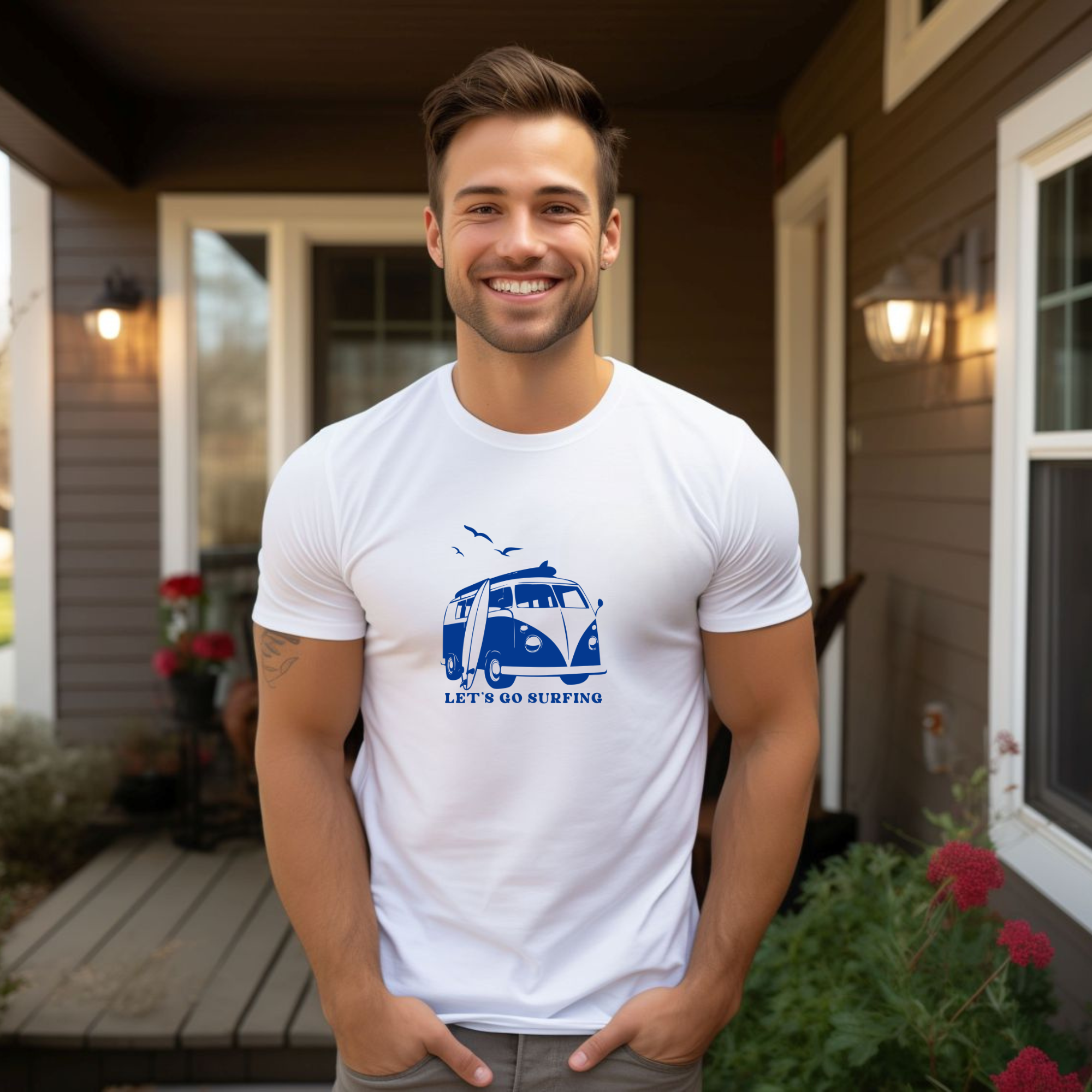 Man wearing a white t-shirt with a blue graphic and text, standing on a porch.