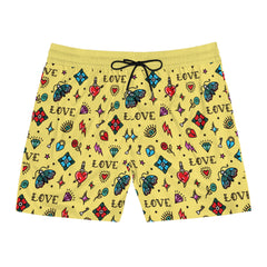 Yellow shorts with colorful tattoo-style patterns on a white background