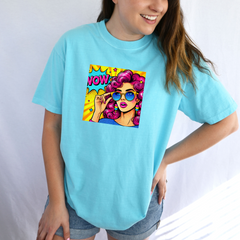 Person wearing a light blue t-shirt with a colorful graphic design on a white background