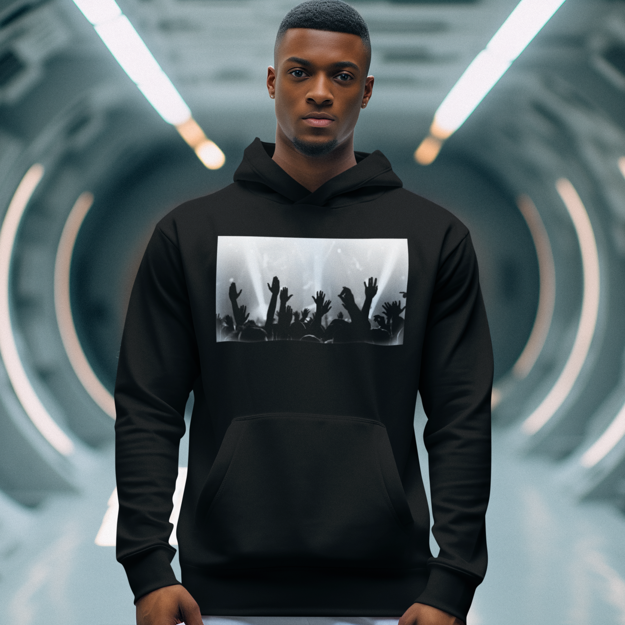 Person wearing a black hoodie with a graphic design in a futuristic setting