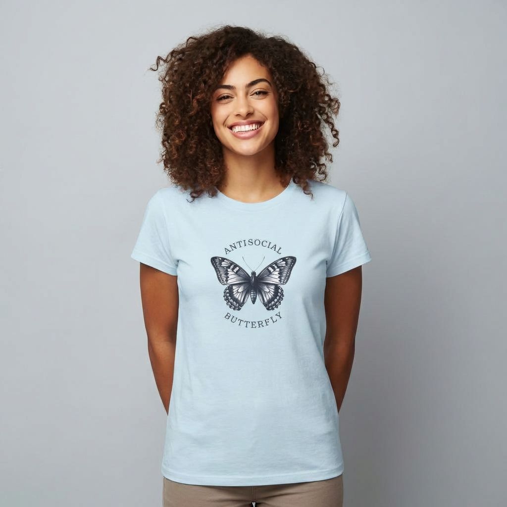Woman wearing a light blue t-shirt with a butterfly graphic and text on a plain background