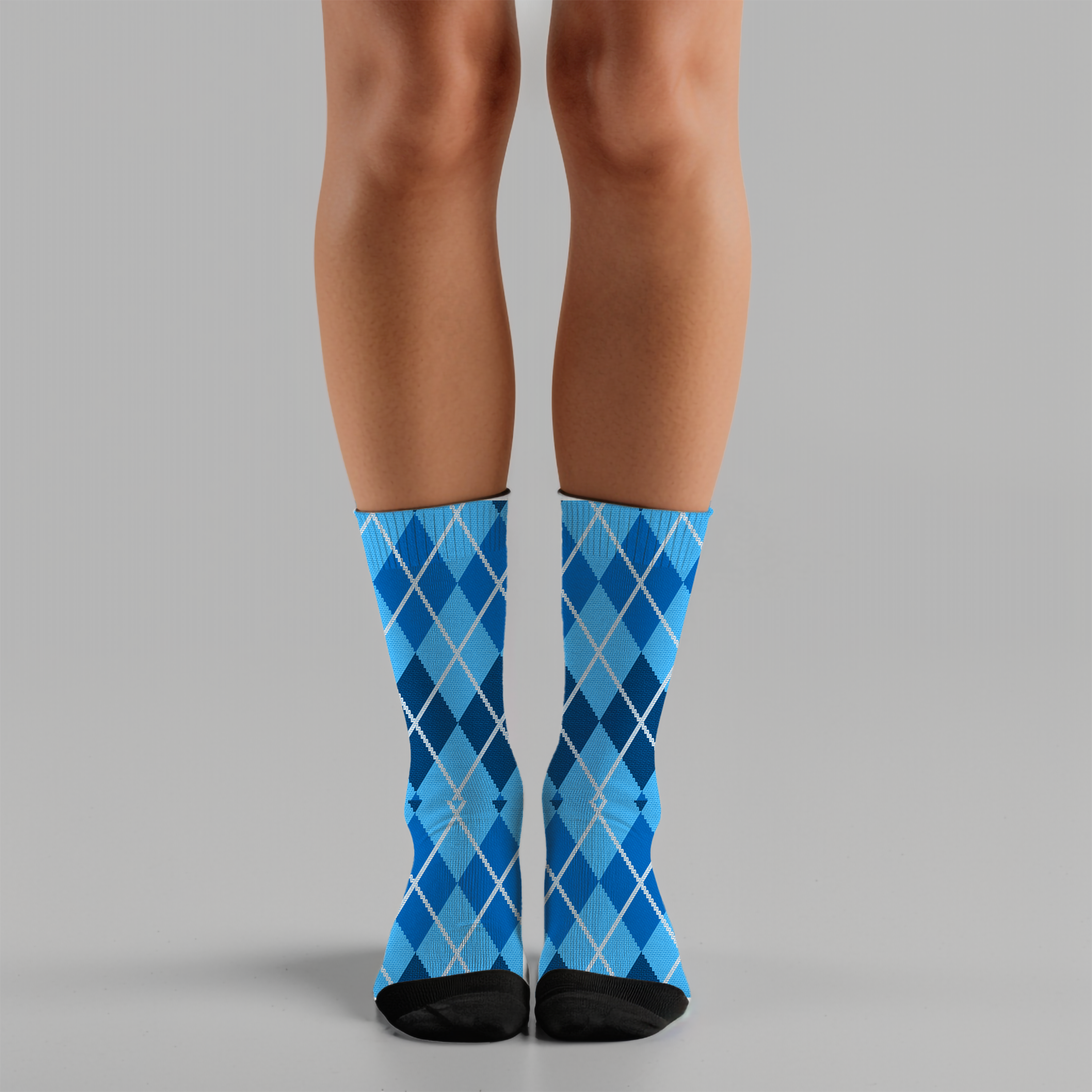 Blue argyle patterned socks worn by a person on a gray background