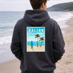 Person wearing a hoodie with a Malibu design on a beach
