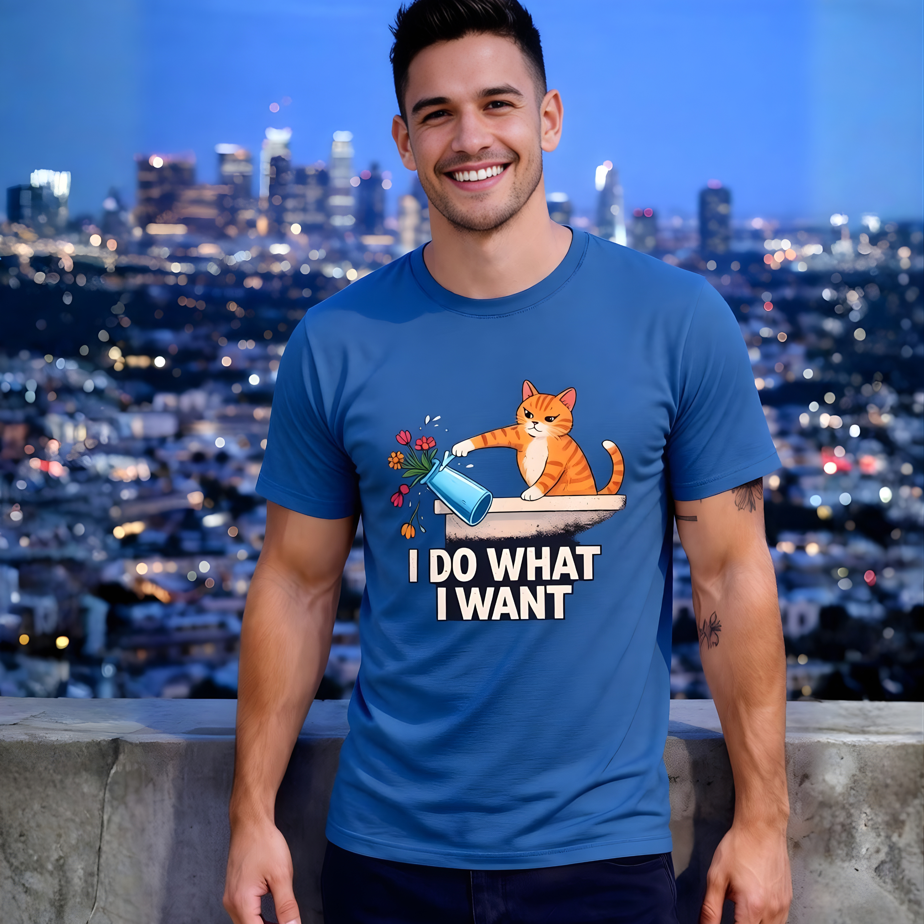 Man wearing a blue t-shirt with a cat graphic and text, standing against a cityscape background.