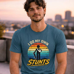 Man holding a skateboard with a t-shirt that says 'I do my own stunts' against a cityscape background.