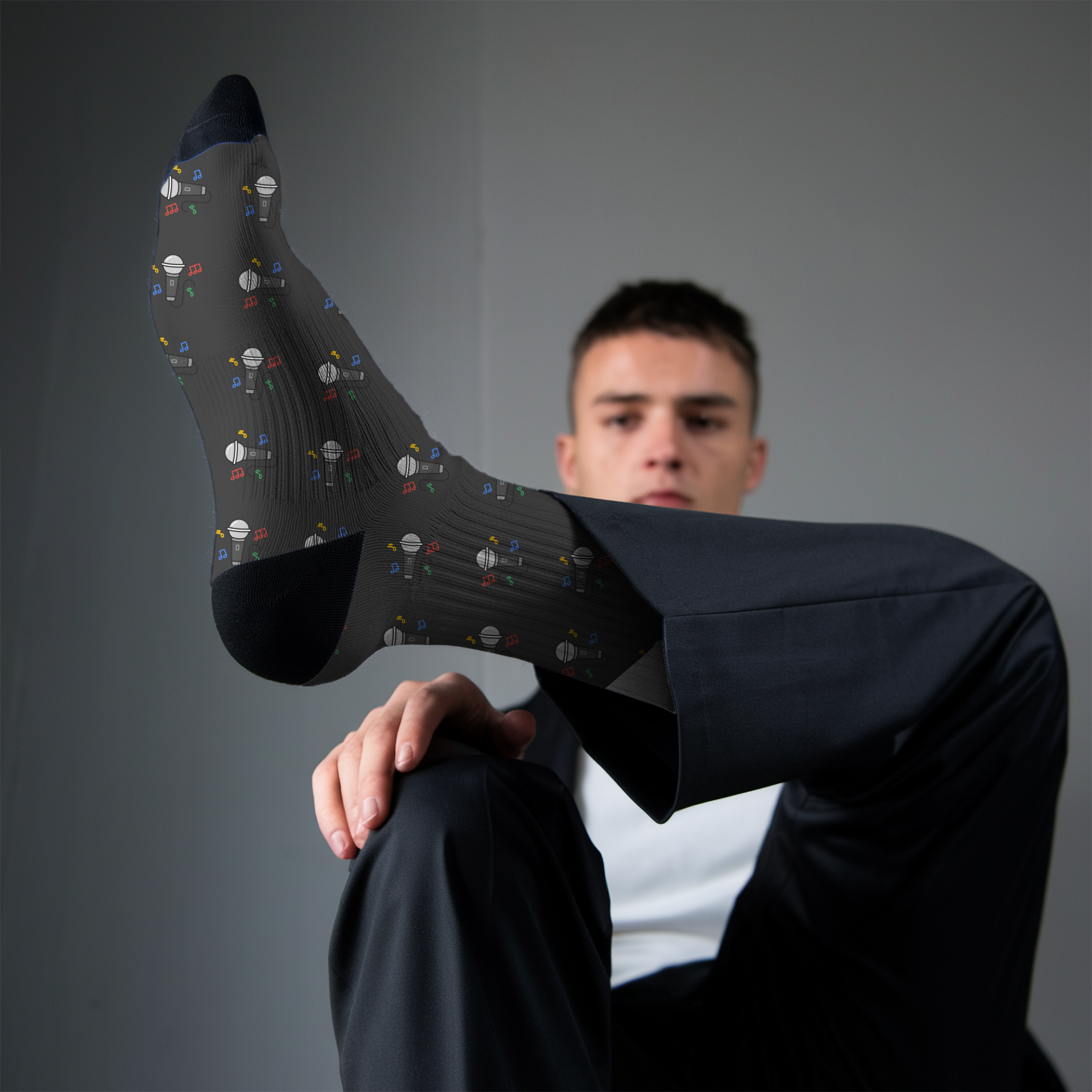 Man wearing black microphone socks against a gray background
