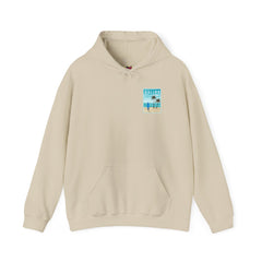 Beige hoodie with a graphic of a beach scene on the chest on a white background