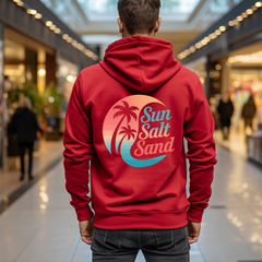 Person wearing a red hoodie with 'Sun Salt Sand' design in a mall