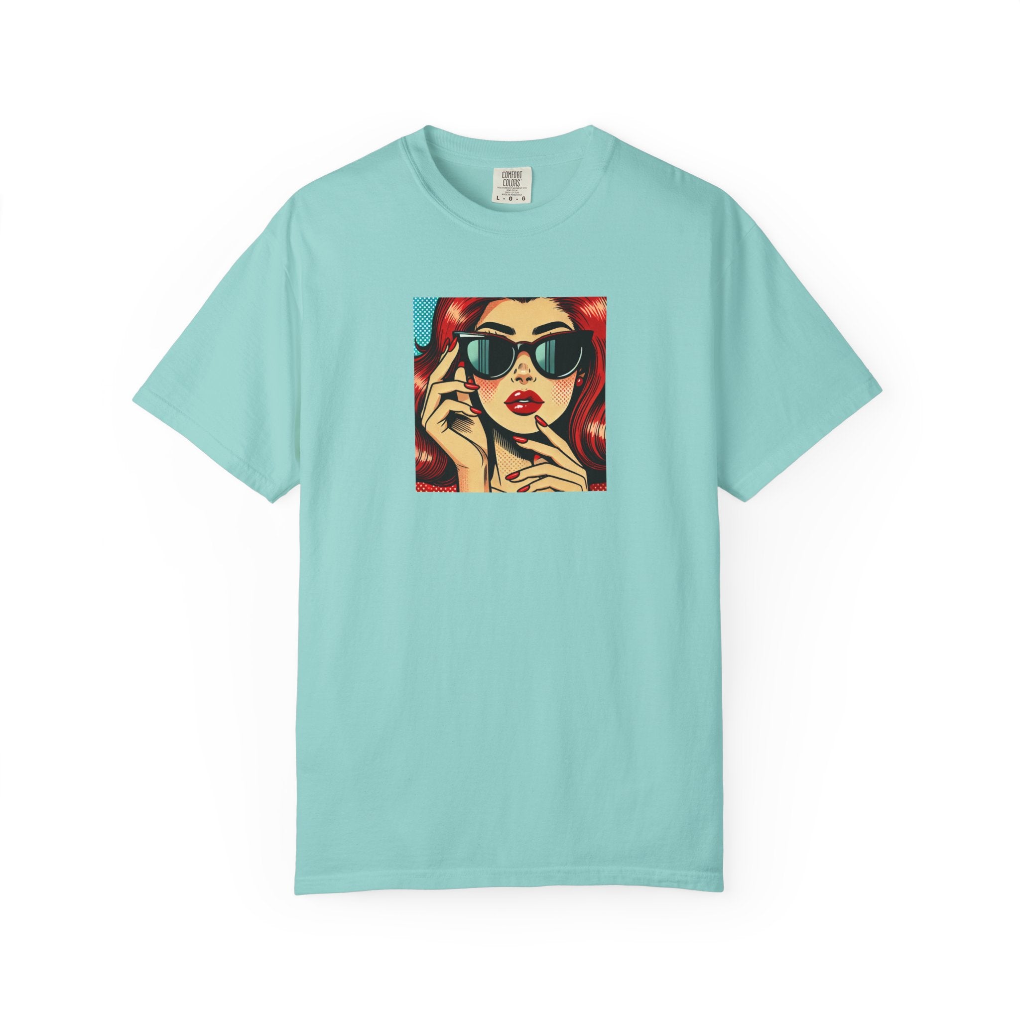 Light blue t-shirt with a graphic of a woman on the phone wearing sunglasses and red hair.