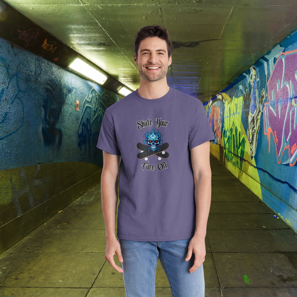 Man wearing a purple t-shirt with graphic design in a graffiti-covered tunnel.