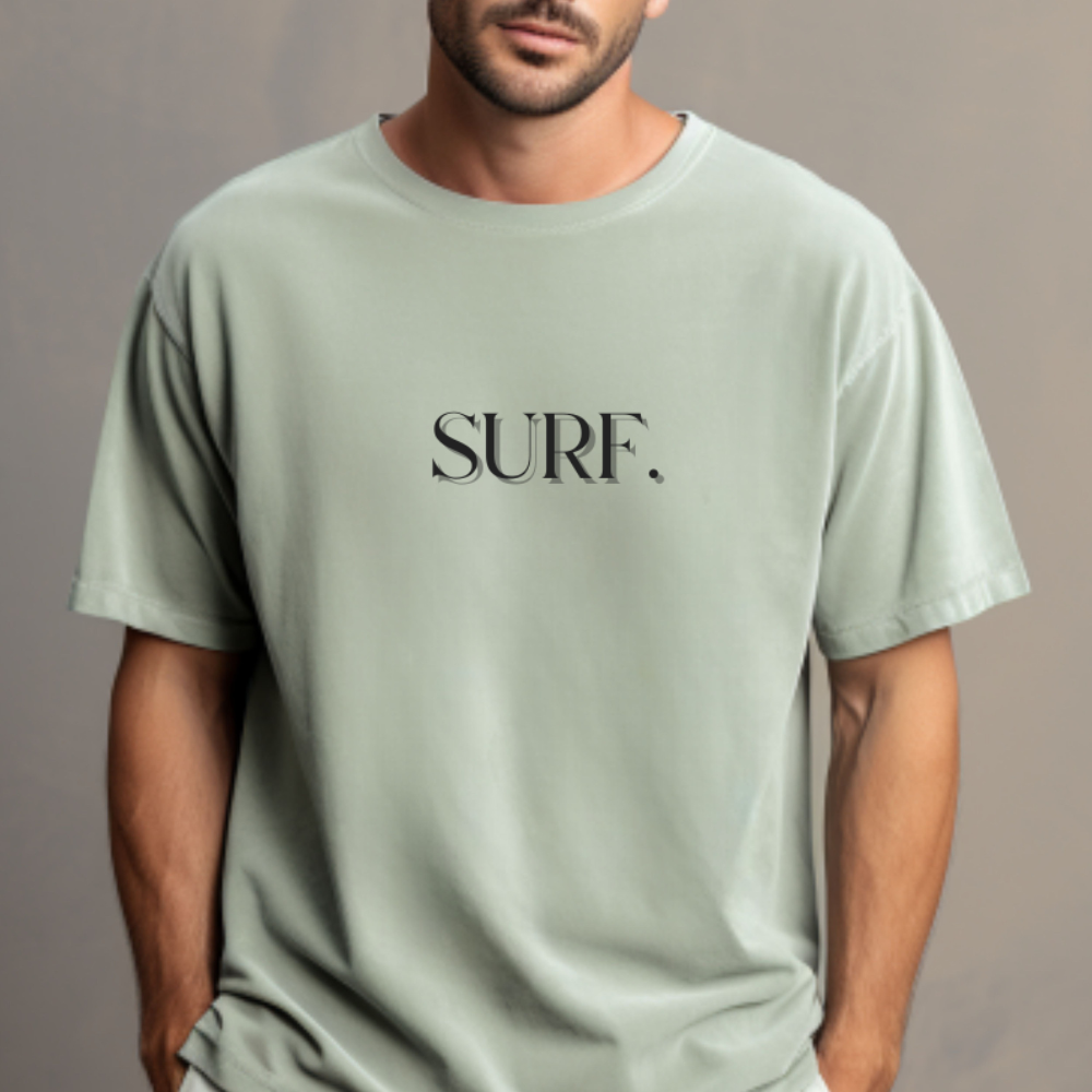 Person wearing a light green t-shirt with 'SURF.' text on a gray background