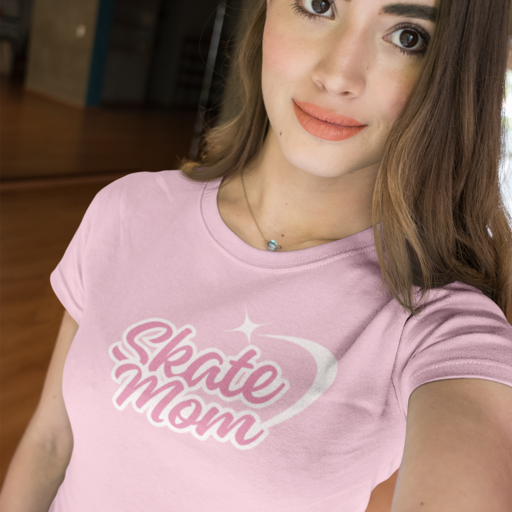 Woman wearing a pink 'Skate Mom' t-shirt indoors.