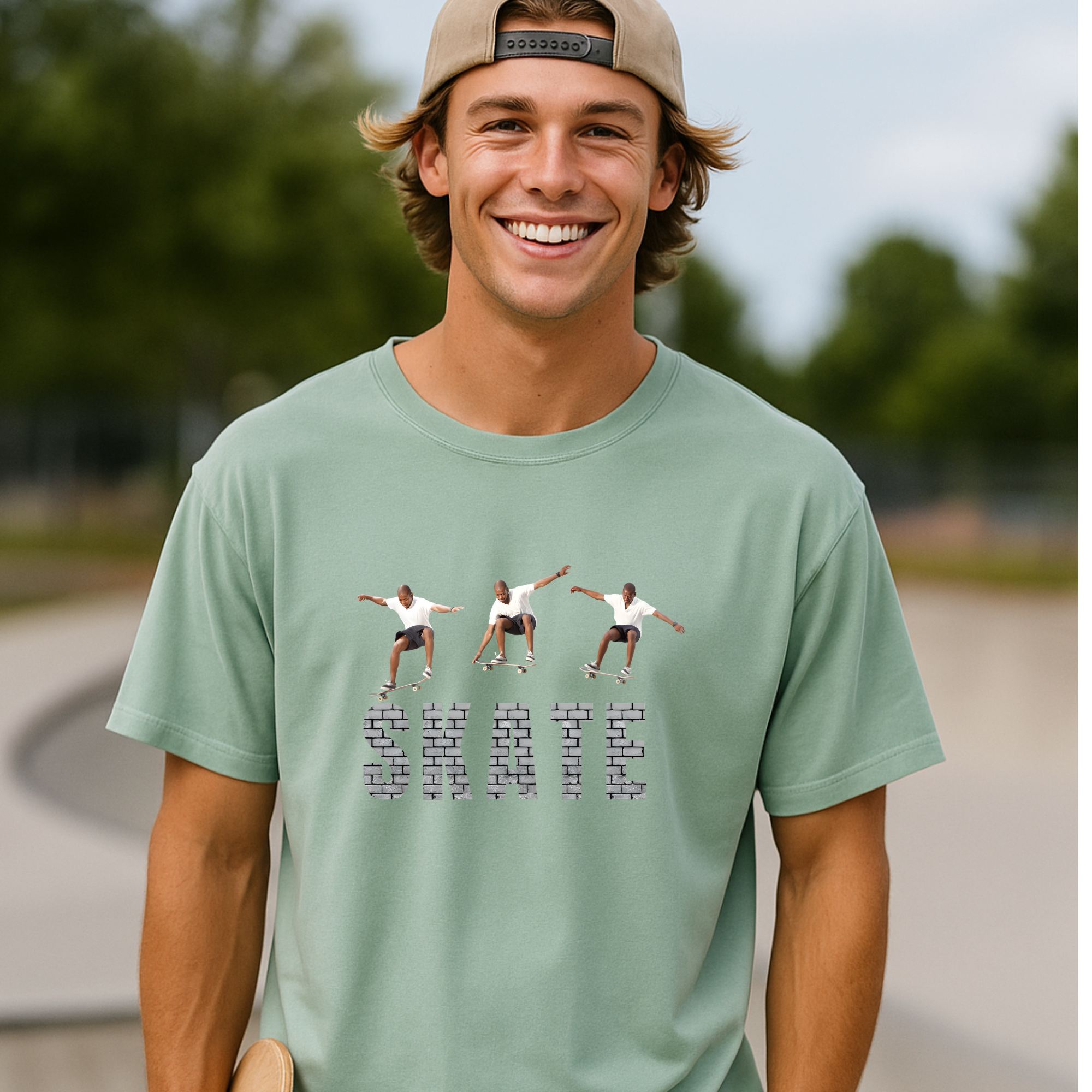 Man wearing a light green t-shirt with graphic design outdoors