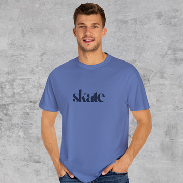 Man wearing a blue t-shirt with 'skate' printed on it against a gray background