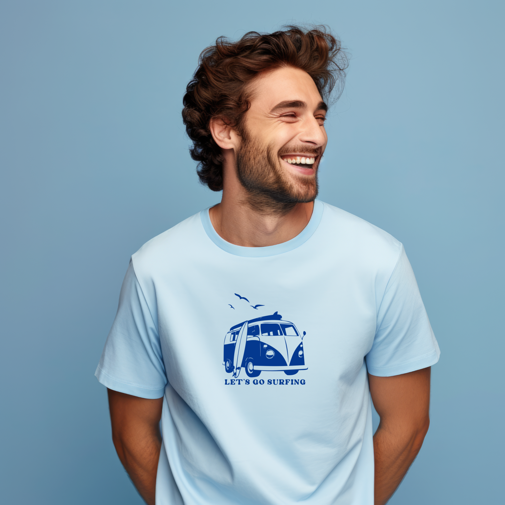 Man wearing a light blue t-shirt with a graphic design on a solid background