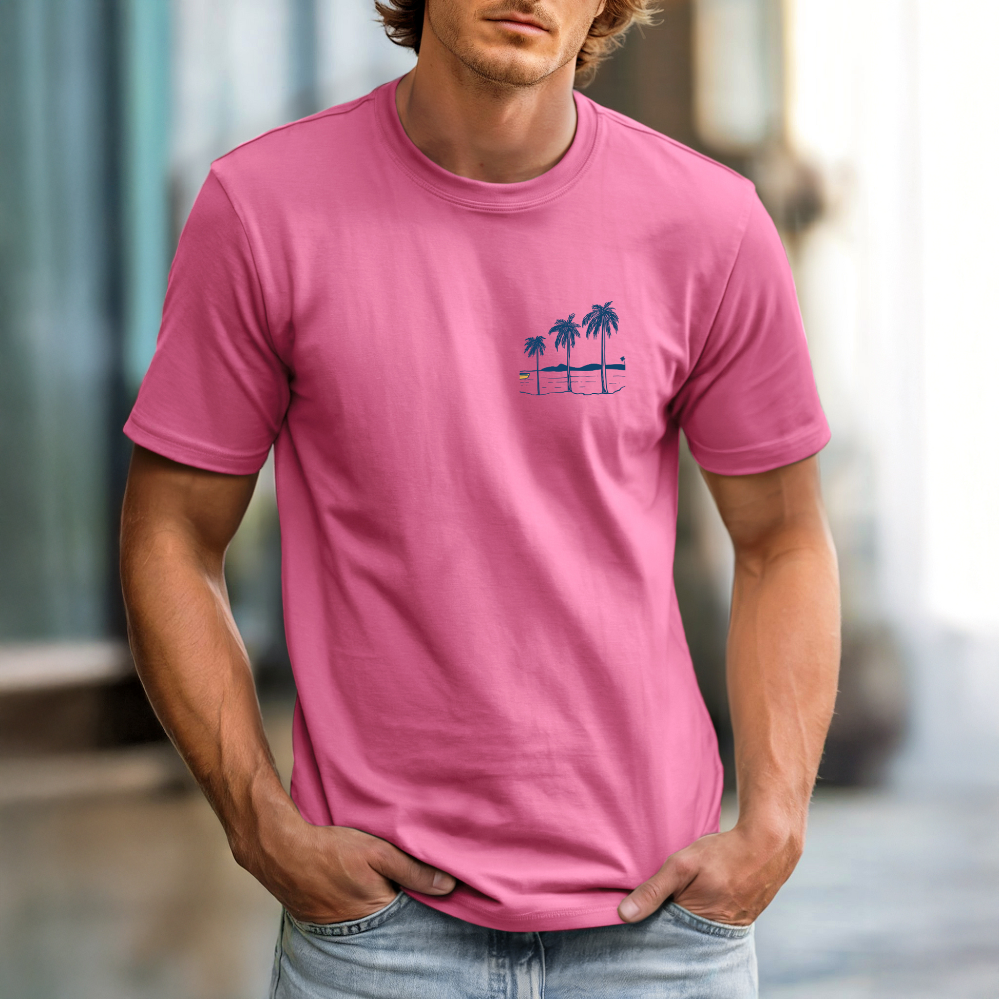 Man wearing a pink t-shirt with a palm tree design in an urban setting