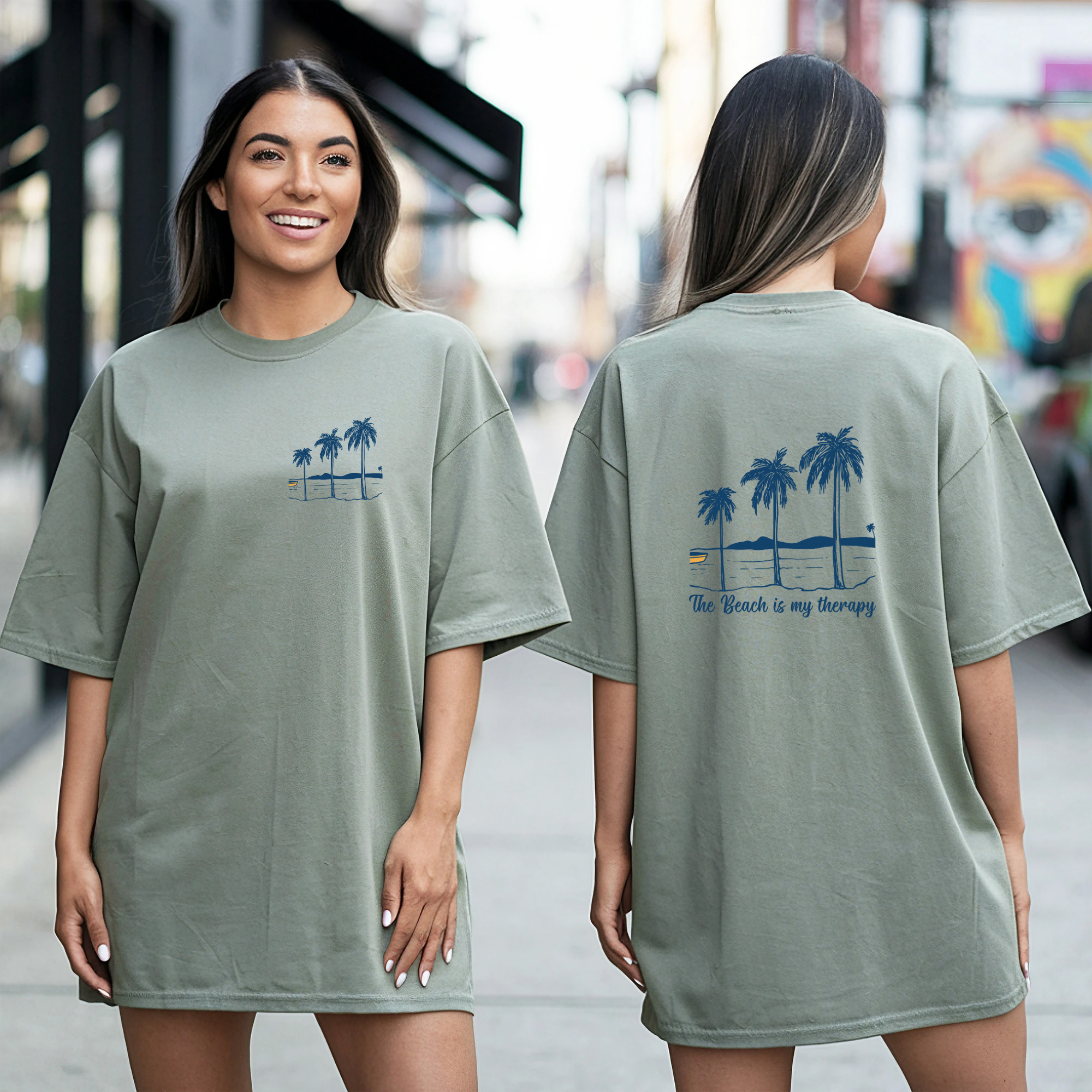 Woman wearing a green t-shirt with palm tree design on front and back, standing on a street.