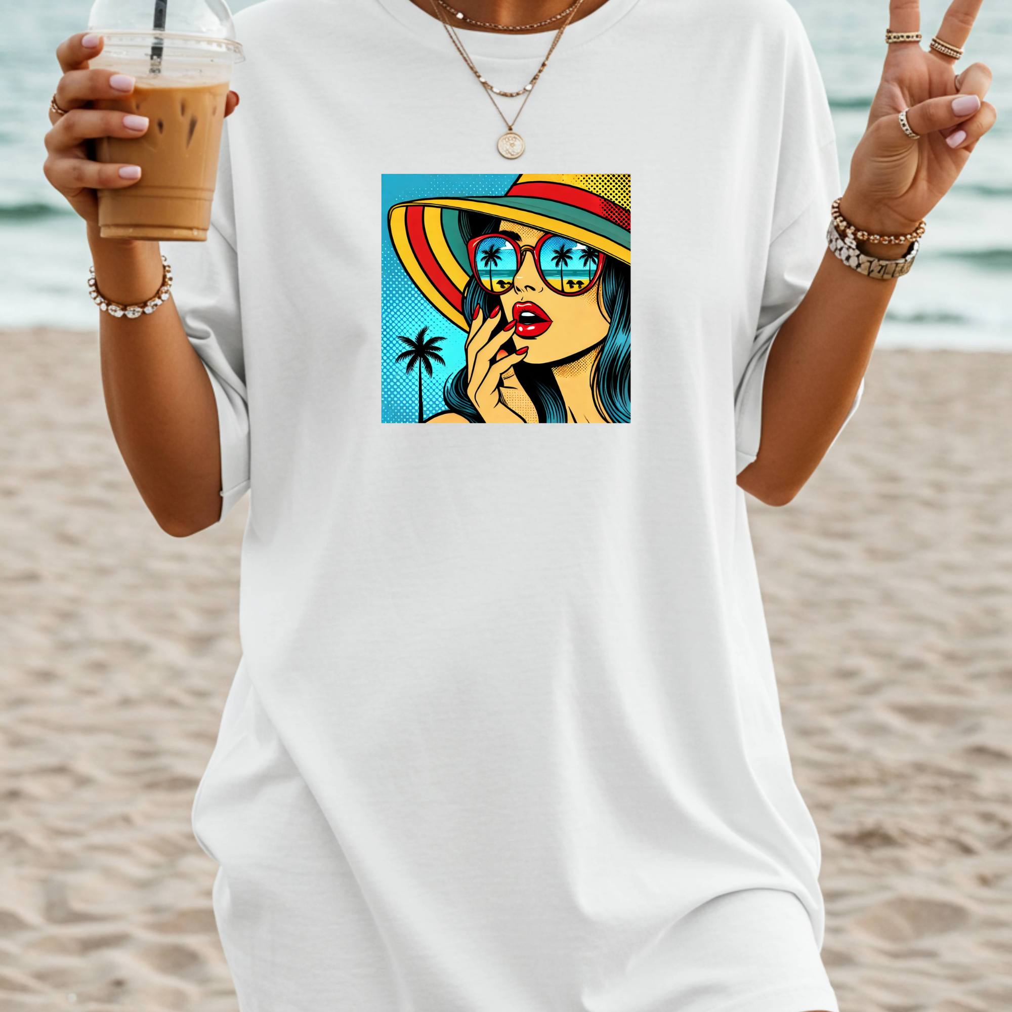 Person wearing a white t-shirt with a colorful graphic of a woman on a beach.