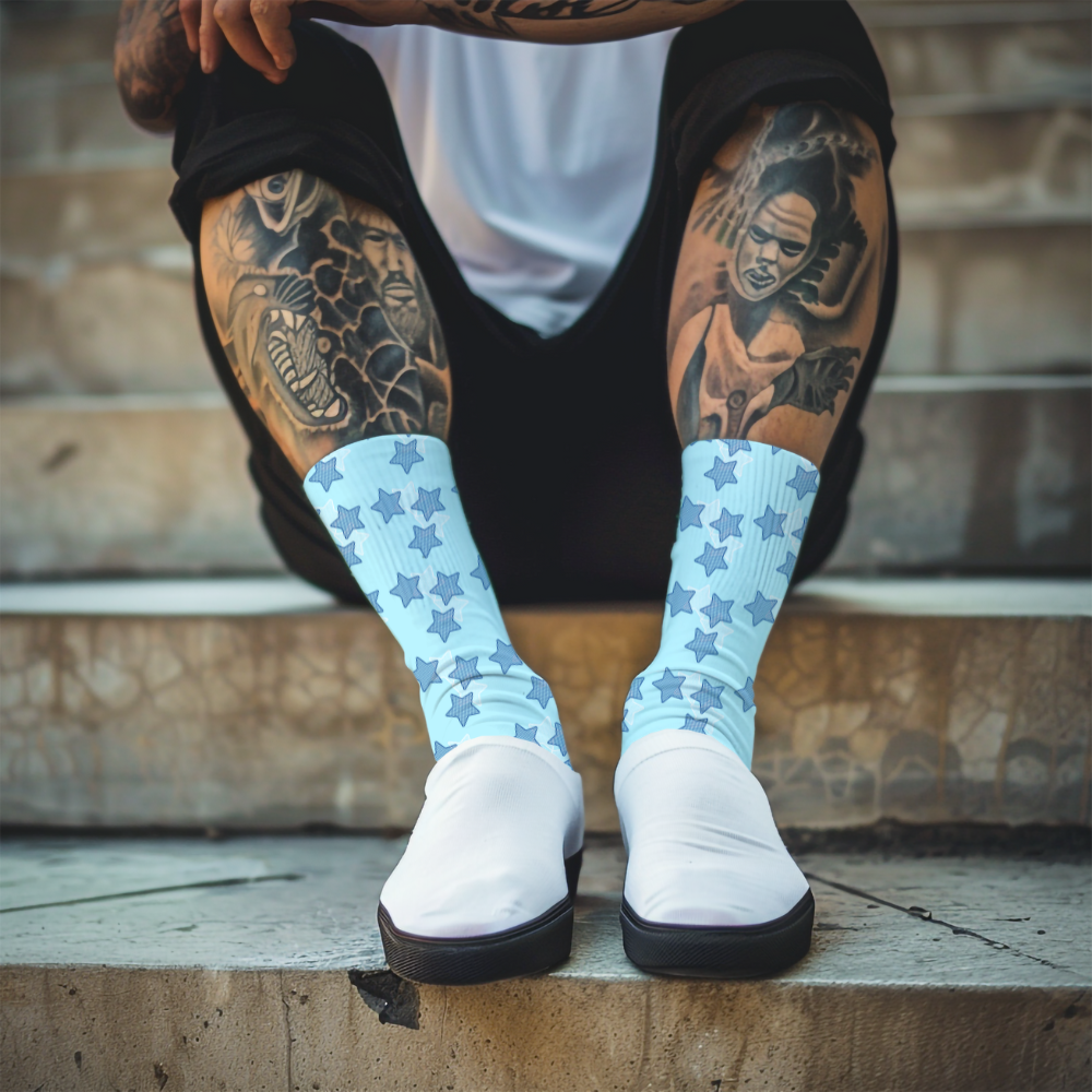 Light blue socks with star pattern worn by a person on a gray background