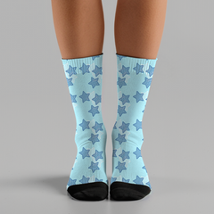 Light blue socks with star pattern worn by a person on a gray background