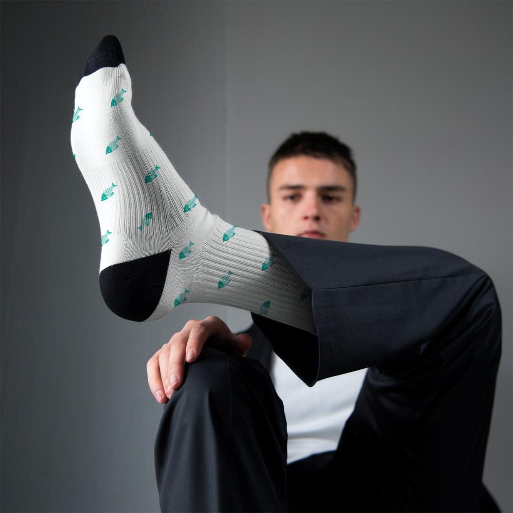 Person wearing a white sock with black toes and heels on a gray background