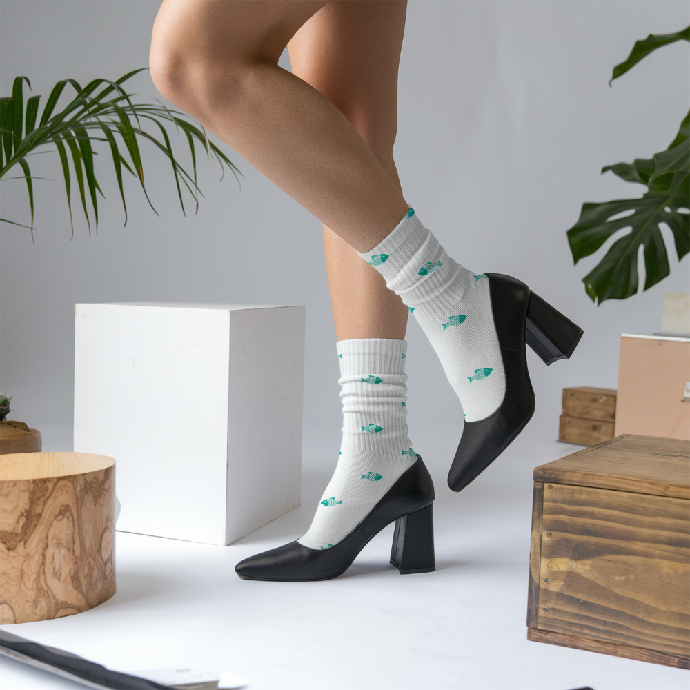 Person wearing white socks with green patterns and black high heels in a minimalistic setting.