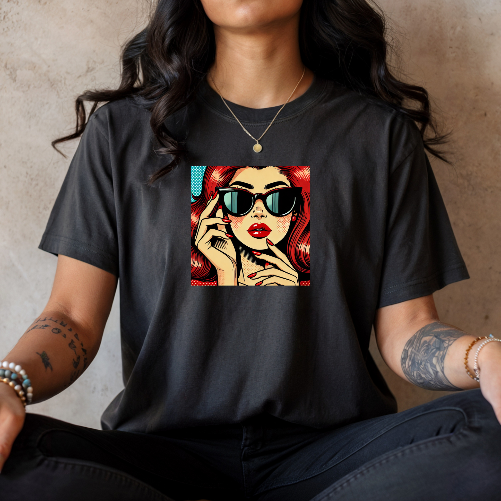 Person wearing a black t-shirt with a graphic design of a woman's face.