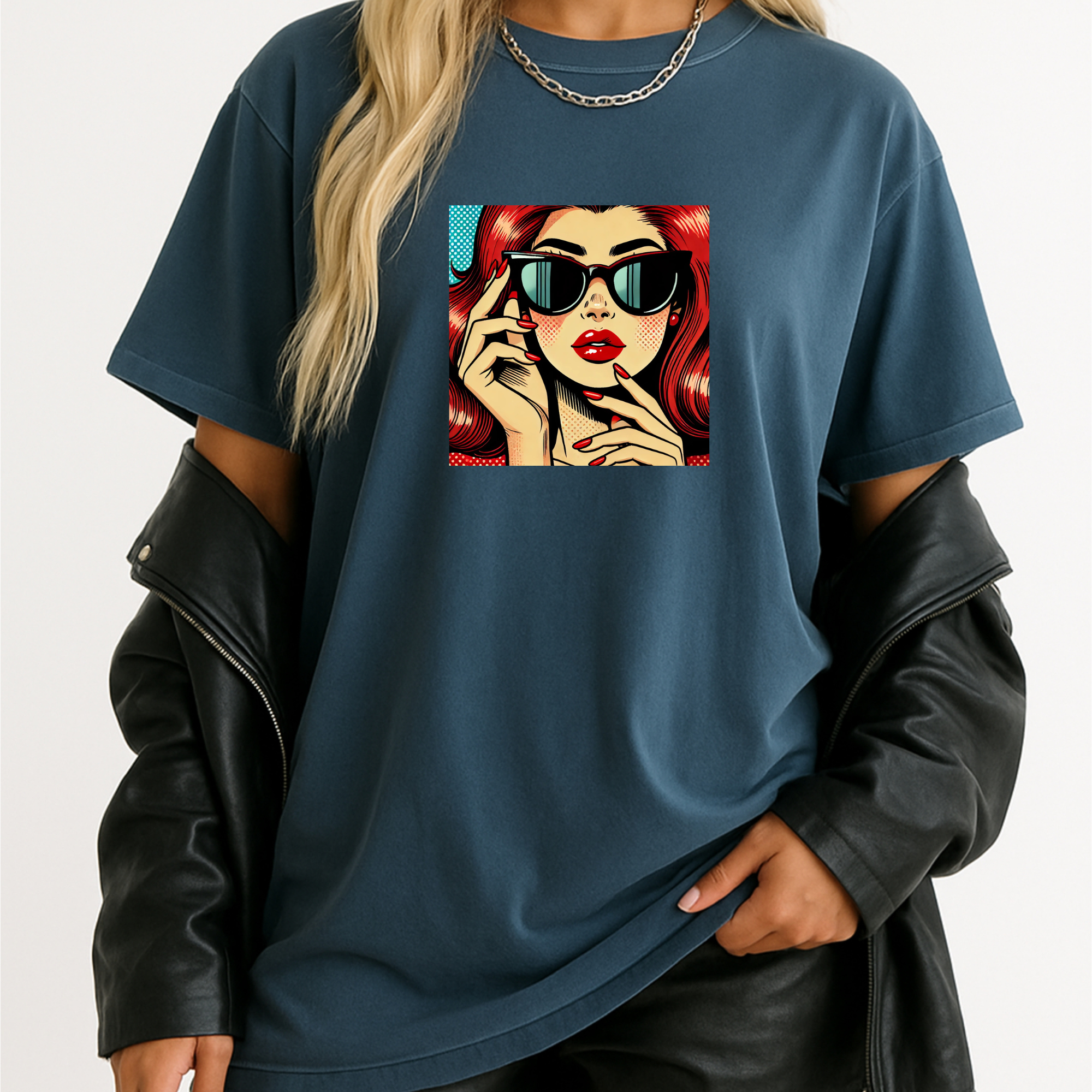 Person wearing a blue t-shirt with a graphic design of a woman with red hair and sunglasses.