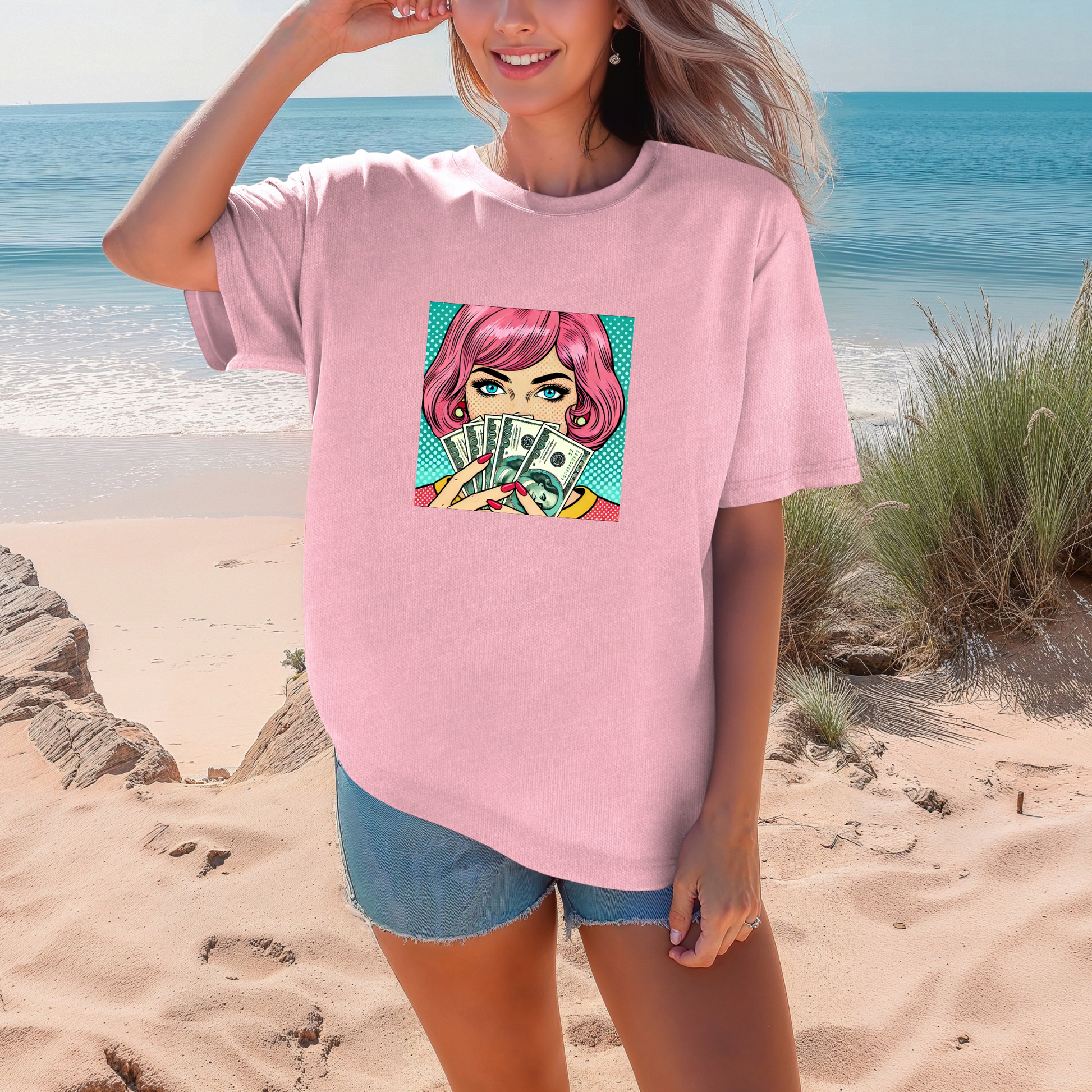 Person wearing a pink t-shirt with a graphic design on a beach