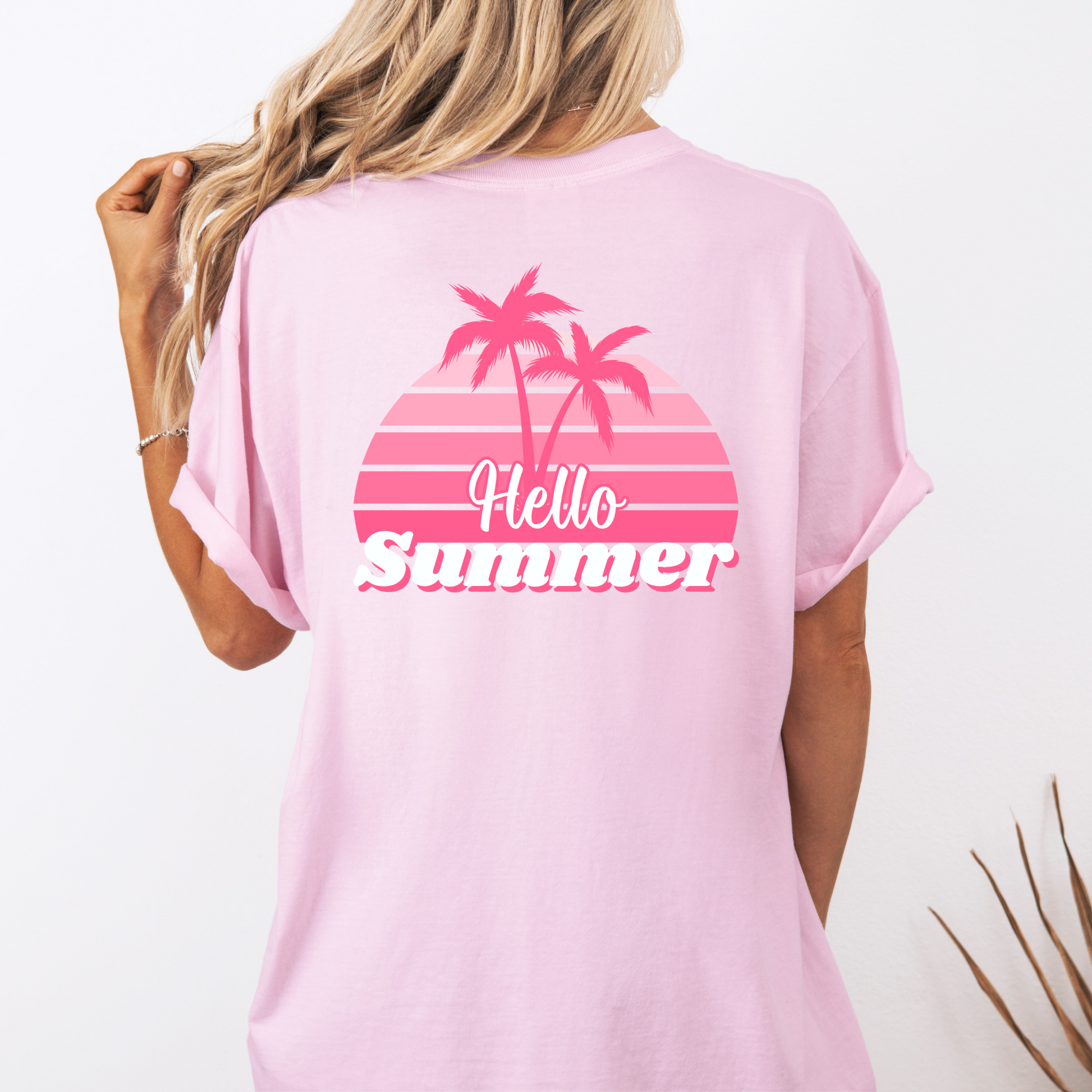 Pink t-shirt with 'Hello Summer' and palm tree design on a white background