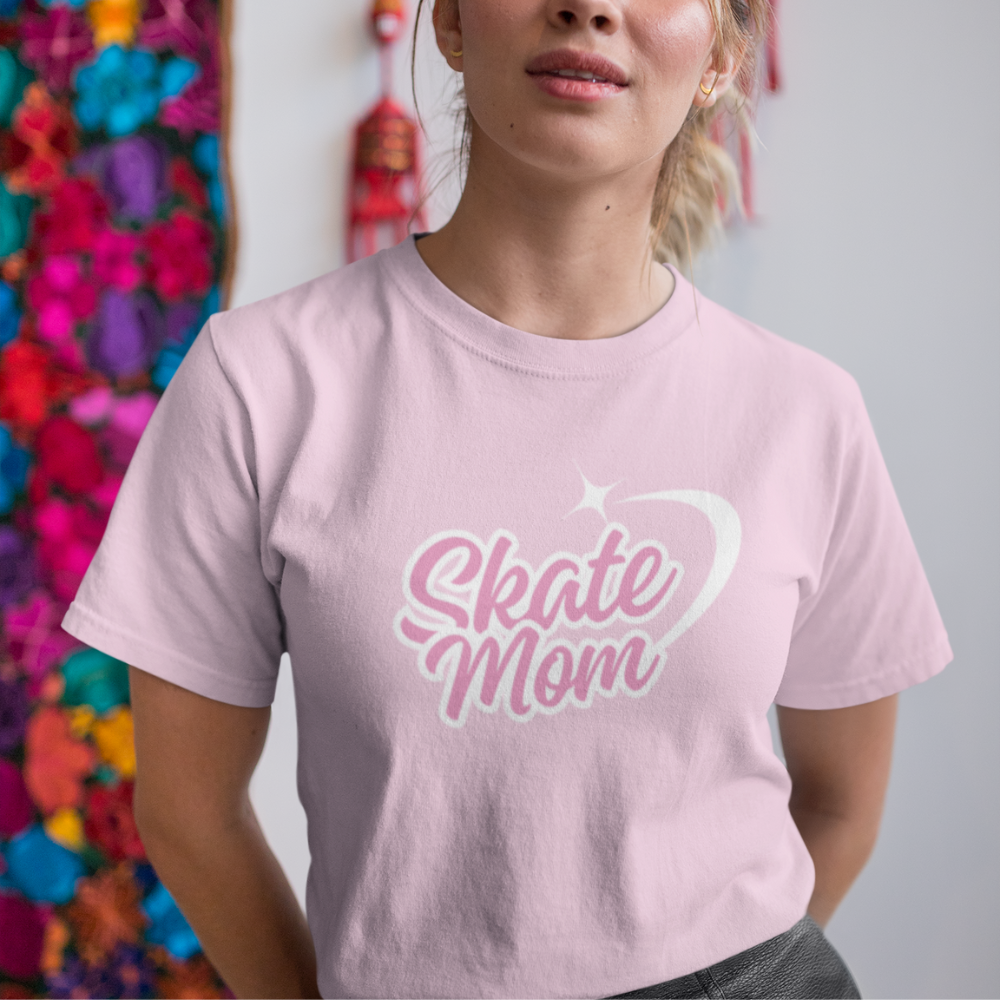 Person wearing a pink t-shirt with 'Skate Mom' text in front of colorful flowers.