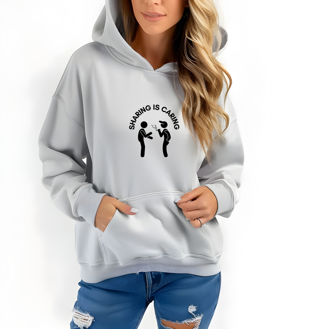 Person wearing a light blue hoodie with a graphic design in a white room.