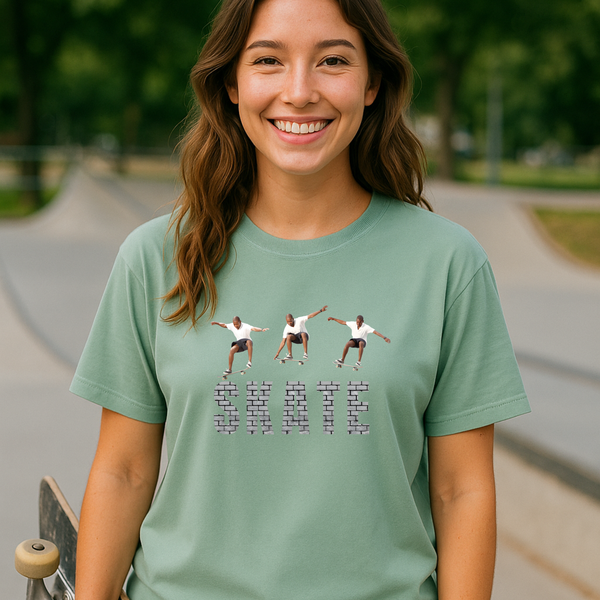 Woman wearing a green t-shirt with a graphic design and text, standing in a skate park.