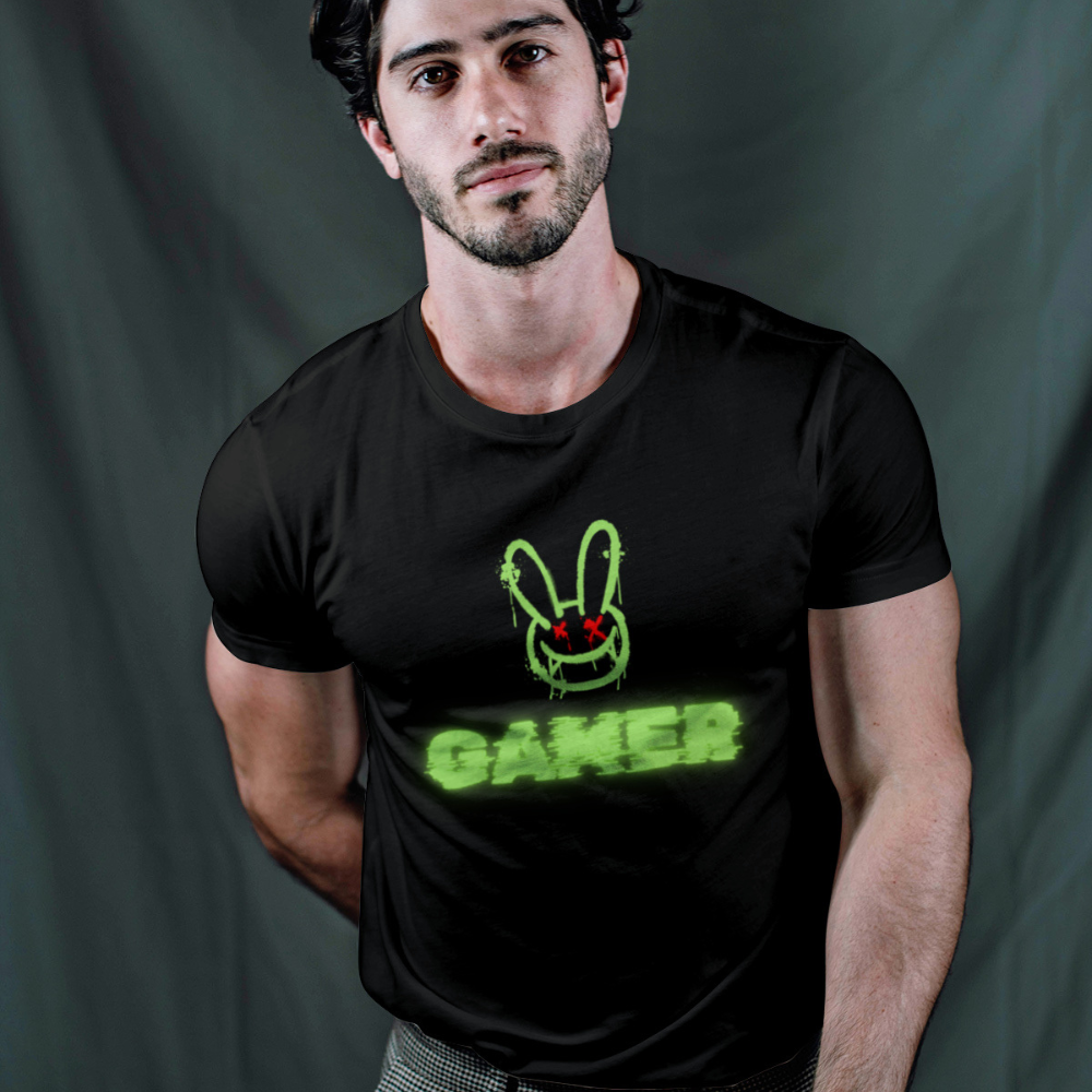 Man wearing a black t-shirt with a green graphic and text on a dark background