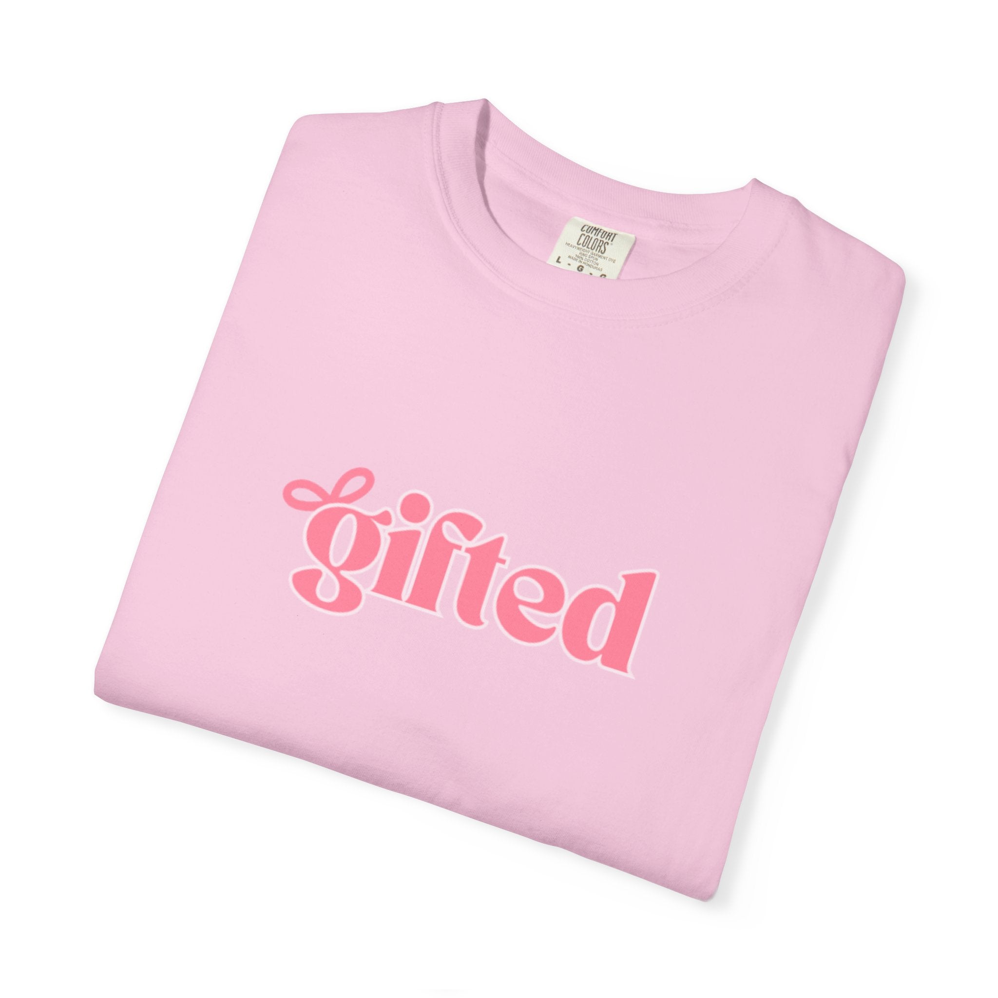 Folded pink t-shirt with 'gifted' text on a white background