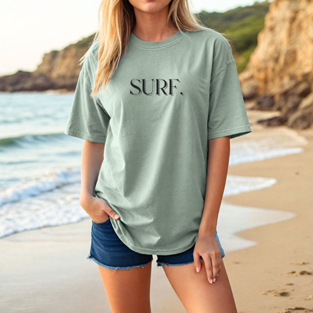 Woman wearing a green 'SURF' t-shirt on a beach