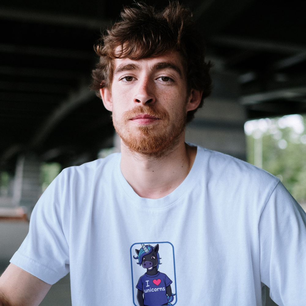 Man wearing a white t-shirt with a graphic design of a cat and text.
