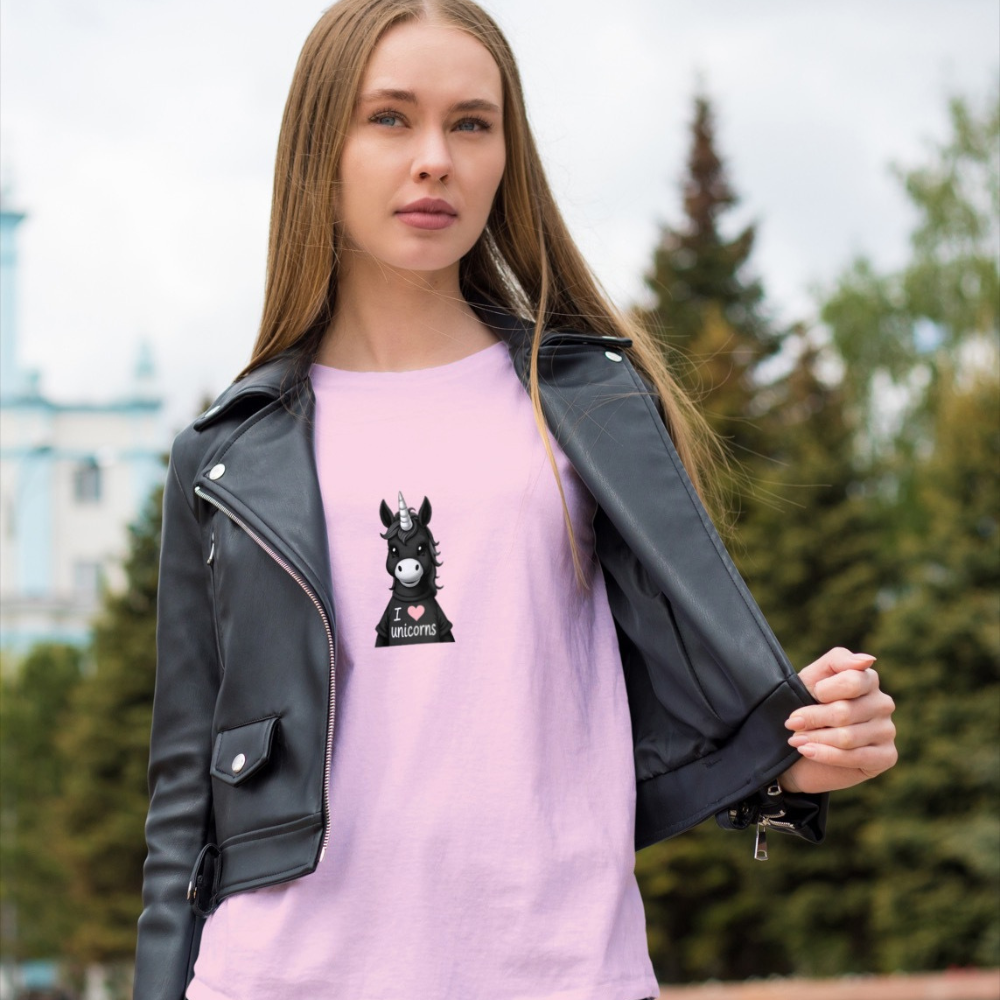 Woman wearing a pink shirt with a graphic design and a black leather jacket outdoors.