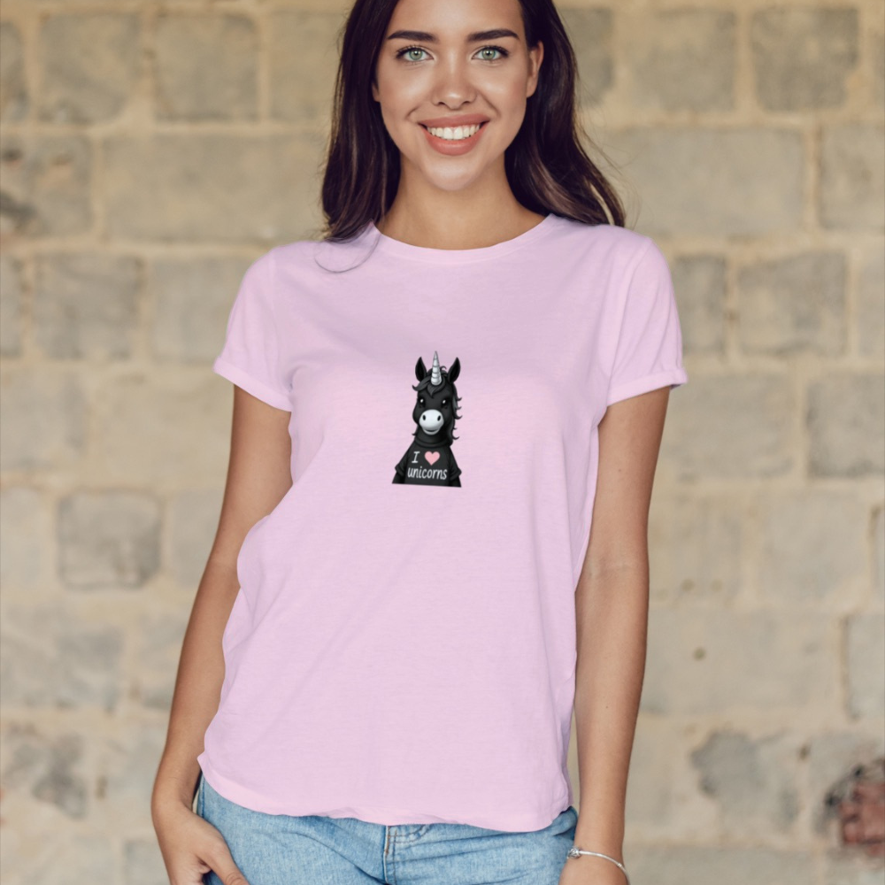 Person wearing a pink t-shirt with a graphic of a donkey unicorn and 'I love unicorns' text, standing against a graffiti-covered wall.