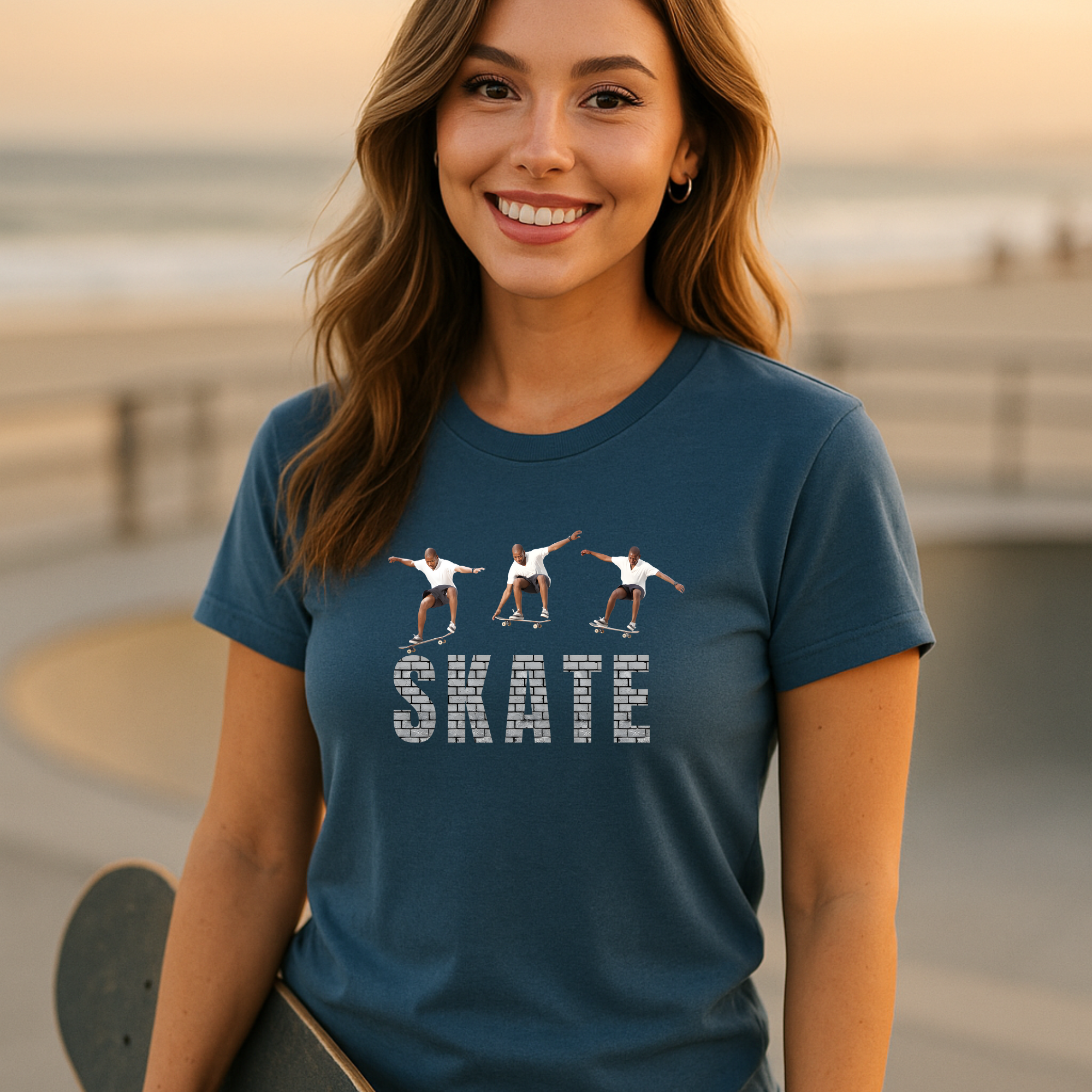 Woman wearing a blue t-shirt with a graphic and the word 'SKATE' at a beach.