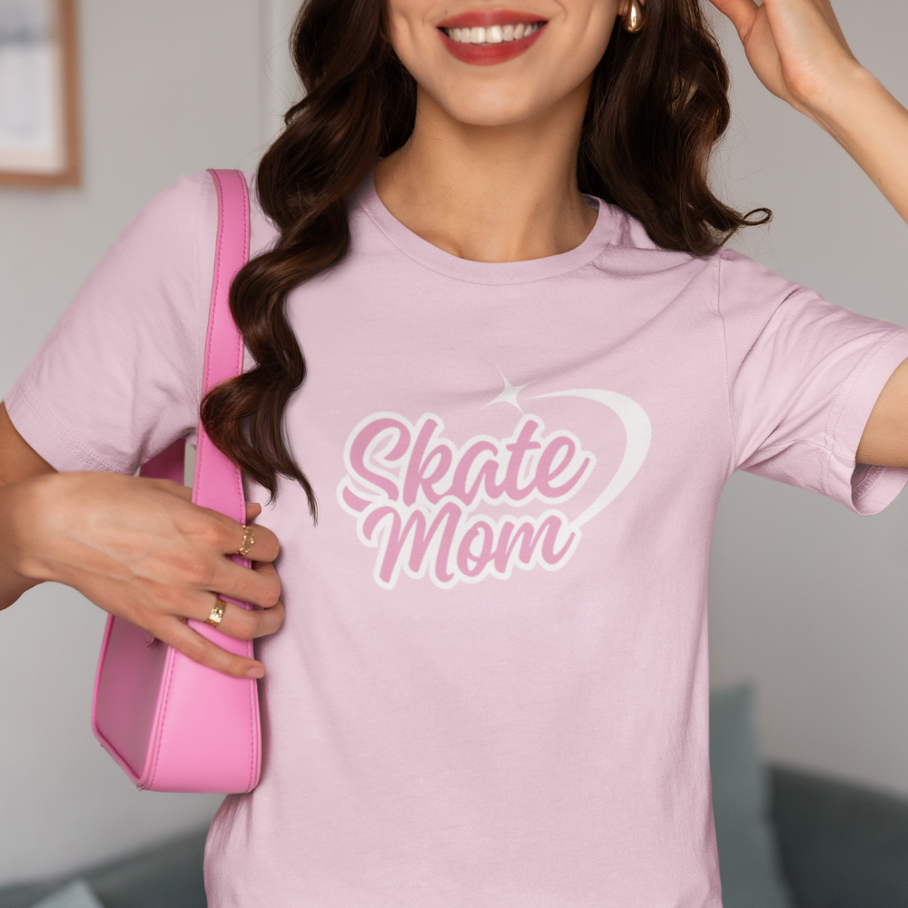Woman wearing a pink 'Skate Mom' t-shirt holding a pink bag.