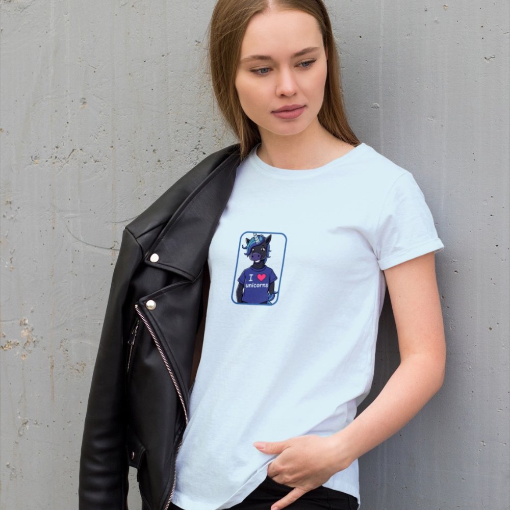Person wearing a light blue t-shirt with a graphic design against a gray wall.