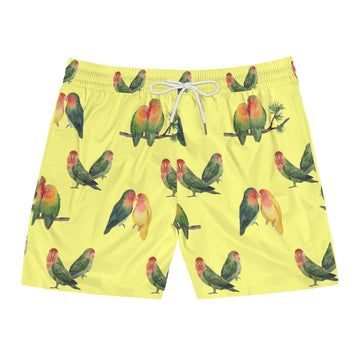 Yellow swim shorts with parrot pattern on a white background