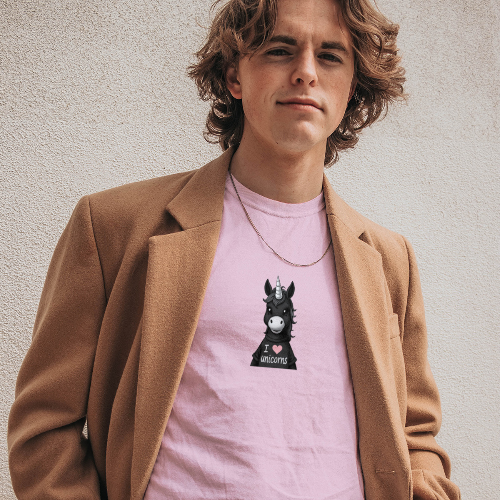 Person wearing a pink t-shirt with a unicorn graphic and a brown coat against a plain background
