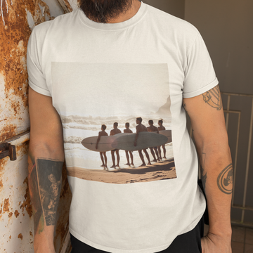 A close up view of an ivory t-shirt with a vintage surfing photo on the front