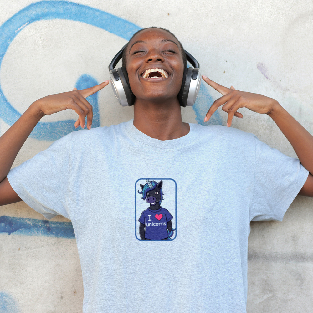 Person wearing a light blue t-shirt with a graphic design, lying on a textured surface.
