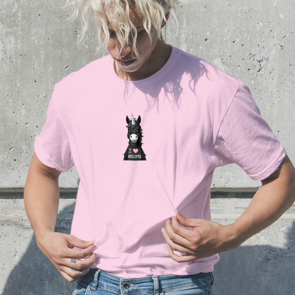 Person wearing a pink t-shirt with a graphic design against a concrete wall.