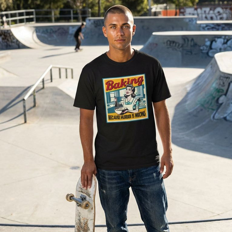 Man holding a skateboard at a skate park wearing a black t-shirt with a graphic design.