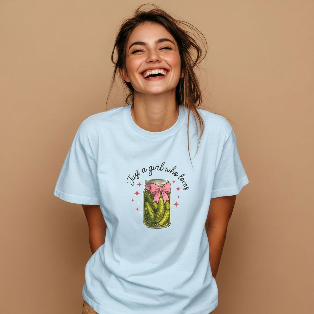 Woman wearing a light blue t-shirt with a graphic design on a beige background
