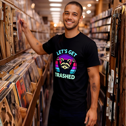 Man in a record store wearing a black t-shirt with colorful text and a raccoon graphic.